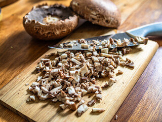 Raw chopped portobello mushrooms on wooden table