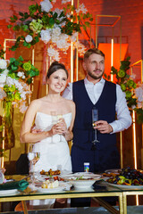 The bride and groom listen to congratulations and toasts from guests