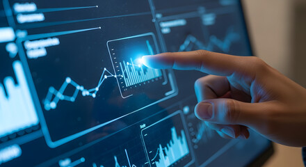 A hand touching a digital screen displaying financial charts and data analysis visualizations in blue tones

