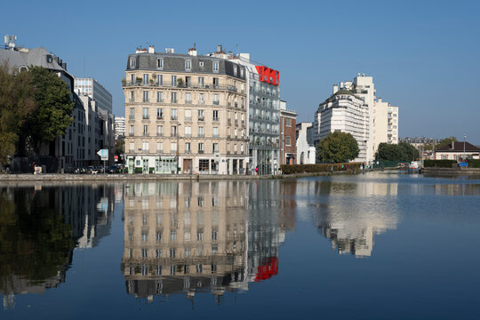 Paris, France - 10 12 2025: Ourcq Canal. Panoramic view of La Villette Basin with buildings, trees reflecting on the water from the quay