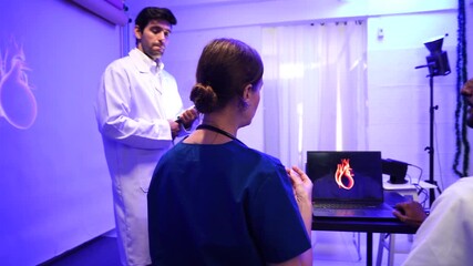 group of female and male doctors of Asian and black backgrounds met to discuss treatment methods and study body system information for nighttime care in a hospital