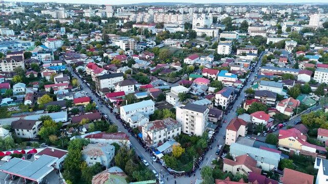 Drone view of Iasi, Romania, showing long lines of pilgrims heading toward the Metropolitan Cathedral during the Saint Parascheva religious celebration