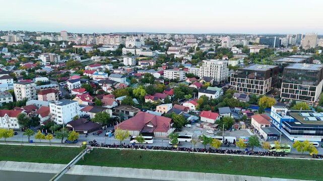 Aerial drone pan over Iasi, Romania, showing the Bahlui River, the Metropolitan Cathedral, and pilgrims gathered for the Saint Parascheva celebration