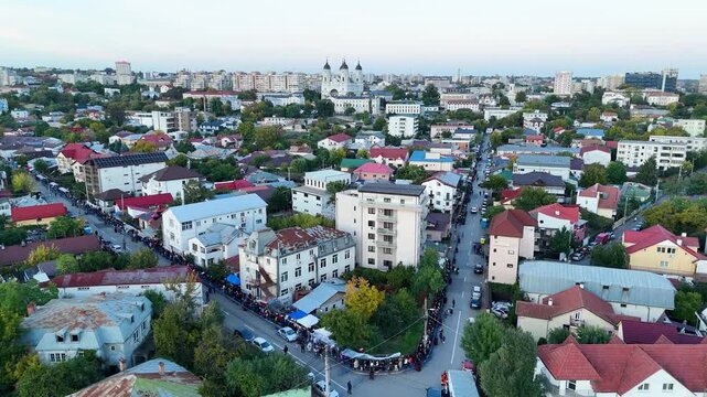 Drone aerial video showing a long line of people walking toward the Metropolitan Cathedral in Iasi, Romania, during the Saint Parascheva religious pilgrimage