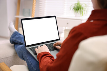 Woman working with laptop indoors, closeup. Mockup for design