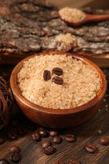 Natural sea salt and coffee beans on wooden table, closeup
