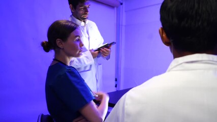 group of female and male doctors of Asian and black backgrounds met to discuss treatment methods and study body system information for nighttime care in a hospital 