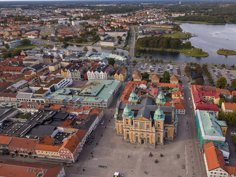 Aerial view of Kalmar Cathedral's baroque grandeur dominates the cityscape, framed by the Stortorget square and the distant waters of the Kalmarsund, Kalmar, Kalmar County, Sweden.