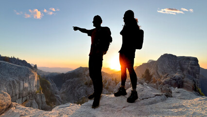 Two friends are having a good time in nature, planning new routes.