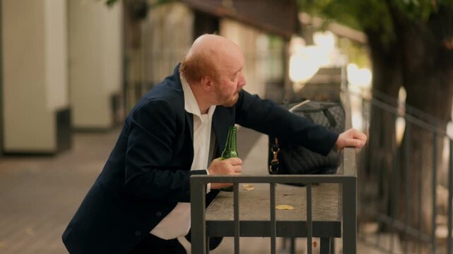 Old drunk office worker leaning and drinking showing social addiction