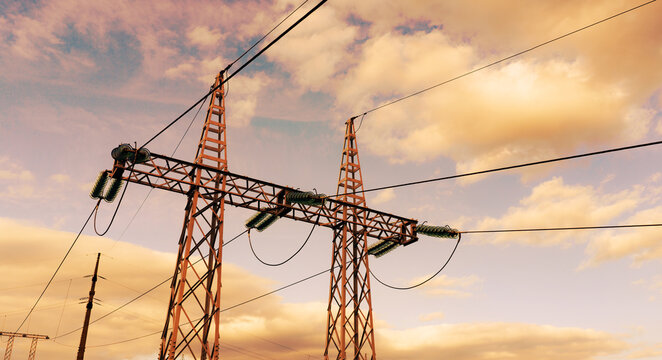 Modern high-voltage power lines and infrastructure for renewable energy under warm evening sky.
