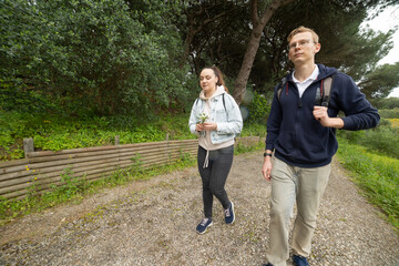 Fototapeta premium Young couple enjoying walking on nature path