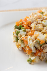 Russian salad ensaladilla rusa serving on white plate