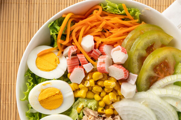 Fresh nutritious salad bowl with mixed vegetables and eggs