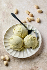pistachio ice cream scoops on beige plate