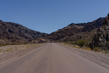 Road at the mountains in arid desert landscape