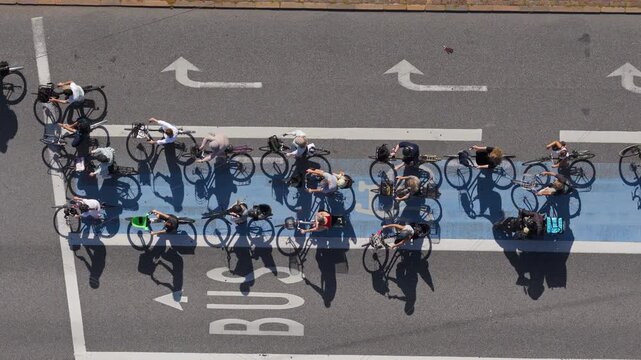 Aerial drone view of a large group of cyclists waiting at a traffic light in Copenhagen, Denmark