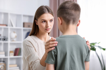 Mother supporting her upset son at home