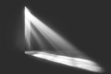 Dramatic light rays stream through a hole, illuminating a dark space