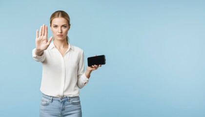 Confident young caucasian woman making stop gesture holding smartphone for privacy and security education campaign