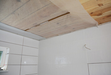 PVC Ceiling Cladding installation. Vapor barrier film for ceiling before installing PVC ceiling panels in the bathroom