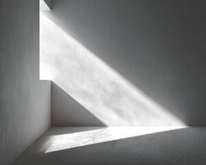 Interior shot, stark shadows define a corner. Light streams through opening