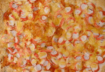 Delicious homemade baked pizza with cheese and surimi toppings.