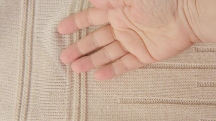 female Hand touching knitted wool cloth or warm fluffy sweater, Handcraft knitting woolen fabric surface, tactile properties, fabric testing - Powered by Adobe