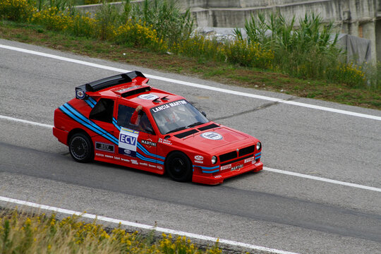 San Marino: 2010 09 01 Rally free event A highly modified red Lancia Delta ECV Experimental Composite Vehicle with the famous Martini racing livery drives on asphalt, with spectators blurred