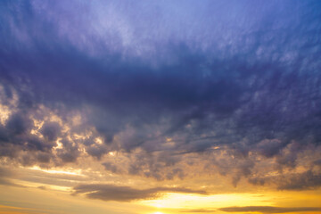 Beautiful colorful evening or morning fluffy clouds in sky. Blue and yellow cloudscape at sunset or sunrise. Nature background.