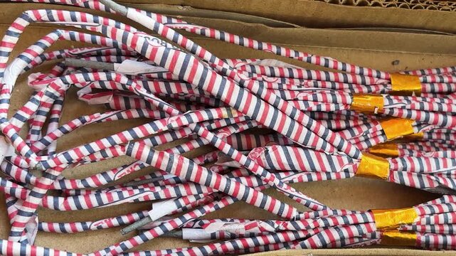striped red blue white firework ladi crackers arranged in cardboard box for diwali celebrations