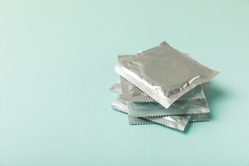 Condoms on a colored background. Colorful fruit-themed condoms in packaging. Safe sex concept. Contraceptive. Different birth control methods. Aids prevention. World AIDS Day. Sexual health.