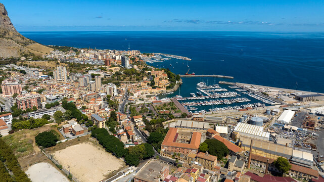 Aerial view of the small Marina Villa Igiea marina in Palermo, Sicily, Italy. Many boats are docked in the touristic port. The Mediterranean Sea is in the background. - Powered by Adobe