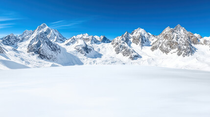 Snowy mountain range beneath crisp blue sky creates breathtaking winter landscape