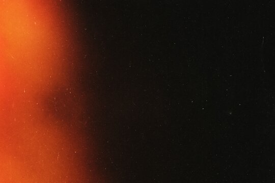 An abstract view of the fiery horizon, with an interplay of light and shadow, grain noise film background