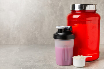 Protein shake with protein powder on a colored background. The powder is mixed with water or milk. A dietary supplement for a balanced diet. Whey protein. Fitness and gym diet nutrition.