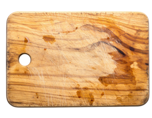 A rustic wooden cutting board with visible scratches and stains, featuring a circular hole for hanging.