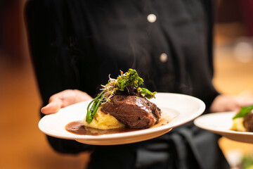 Slow cooked pork cheeks in red wine sauce with mashed potatoes.Braised pork cheeks in brown red...