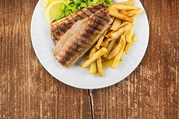 Tasty fresh fish dish on desk background