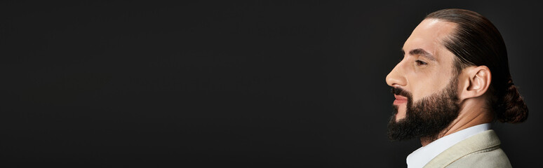 Handsome middle eastern man in stylish outfit poses in a studio setting