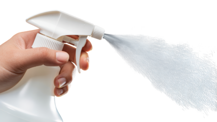 A hand sprays cleaning liquid from a bottle.