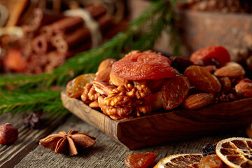 Dried fruits and nuts on an old wooden table.