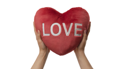 Hands holding a red heart pillow that says LOVE. Isolated on transparent background, png