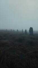 Stone circle in misty landscape