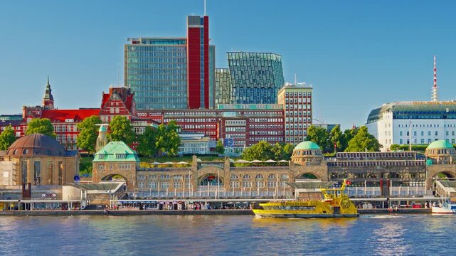 View of Hamburg's waterfront and citycenter and ships and boats passing along the Elbe River at sunset in Hamburg, Germany