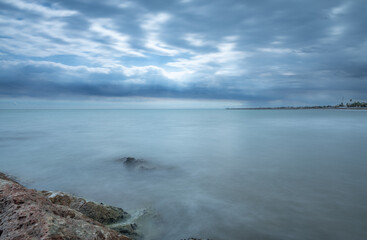 Beach and Mediterranean Sea landscape on the coast of Almenara, Castellón province, Valencian Community, Spain, coastal tourism and summer destination.