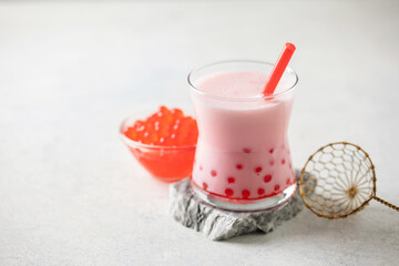 Cold iced fruit bubble tea with juice balls in glass