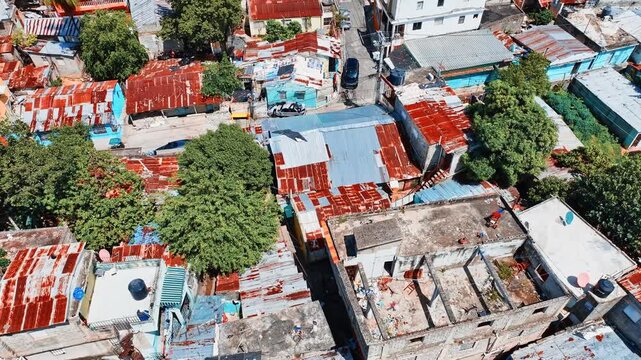 In the slums, houses are piled on top of each other. Aerial view of traditional Dominican dwellings. Slums in the suburbs of the capital. Shot with a drone.