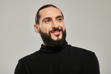 Obraz premium Handsome middle eastern man poses confidently in stylish outfit in studio setting