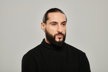 Fototapeta premium Handsome middle eastern man in stylish outfit posing confidently in studio setting